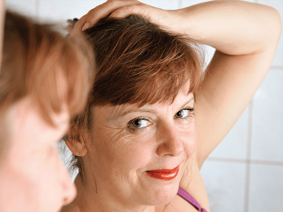 Woman Looking in Mirror