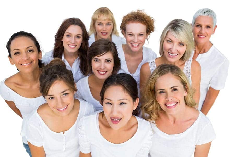 Cheerful female models smiling at camera on white background